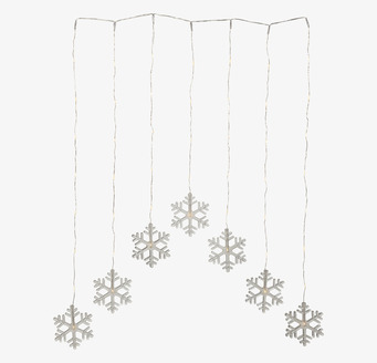 Bild av ljusgardin med snöflingor och varm belysning