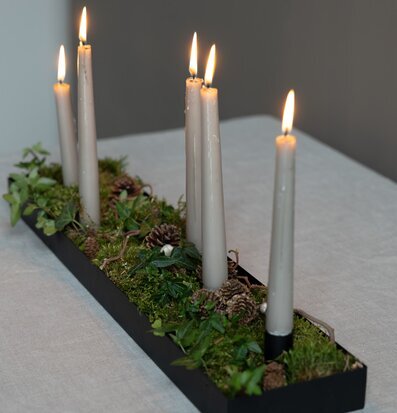 Bild av stilren ljusstake med naturinspirerad dekoration