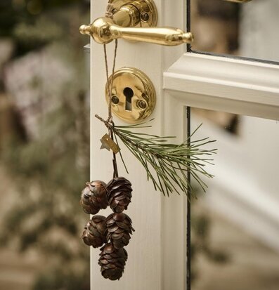 Bild av dörr med mässingshandtag och naturdetaljer