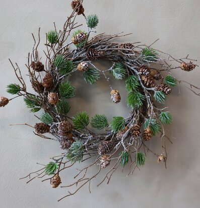 Foto av naturinspirerad krans med kottar och cederträ