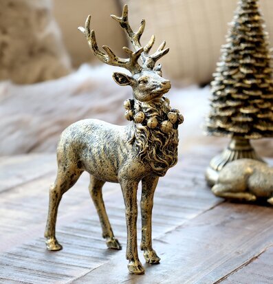 Bild av elegant renfigur i antik mässing med bjällror