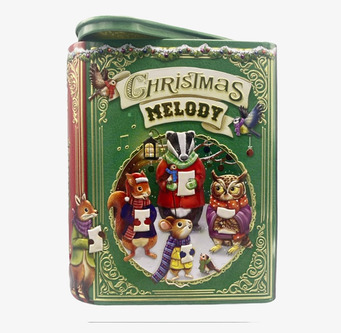 Bild av julinspirerad plåtburk med djur och musikmotiv
