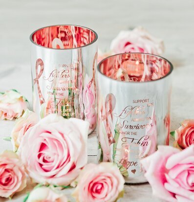 Bild av glittrande ljuslyktor med rosa band och rosor