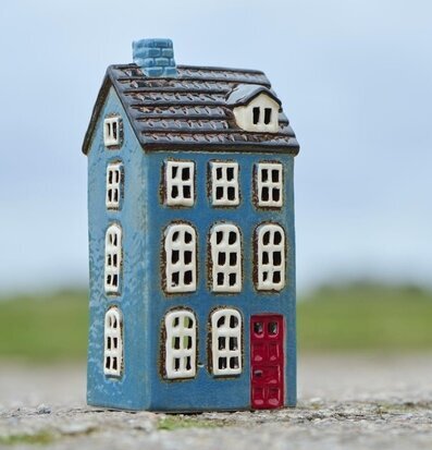 Foto av en blå ljuslykta utformad som ett miniatyrhus