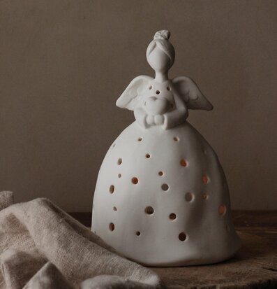 Bild av en stilren och harmonisk keramikängel i vitt