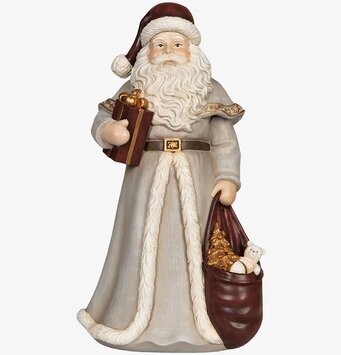 Bild av dekorativ jultomte med gåvor och vinterklädsel