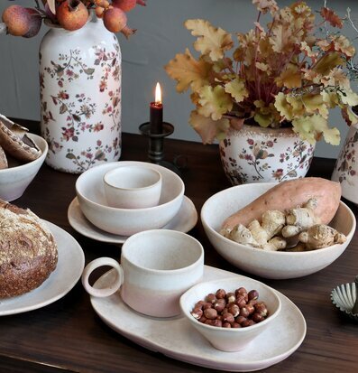 Bild av rustikt dukat bord med keramik och höstdekorationer