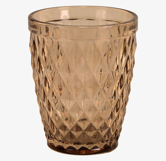 Foto av elegant glas med diamantmönster och honungston