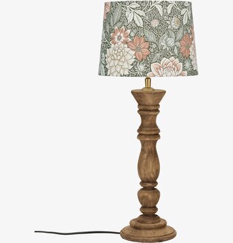 Bild av bordslampa med rustik fot och grön blommig skärm