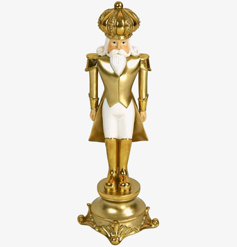 Bild av dekorativ nötknäppare i vita och guldiga toner