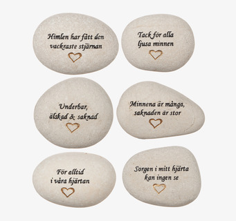 Foto av sex vita stenar med känslosamma gravyrer