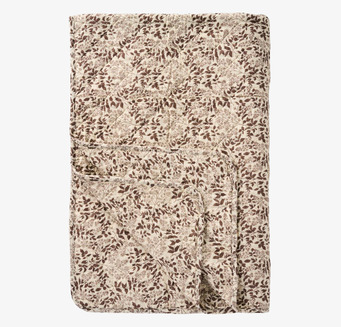 Bild av bomullspläd i jordnära toner och skandinavisk stil