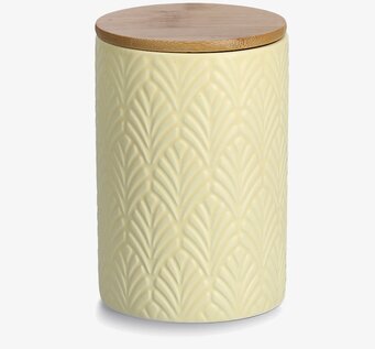 Bild av gul keramikburk med trälock och reliefmönster