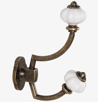 Bild av krok i antik mässing med vit keramikdetalj