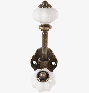 Foto av vintagekrok i antik mässing med keramiska detaljer