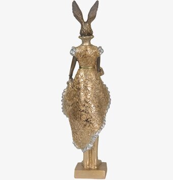 Bild av intrikat gyllene kaninfigur med kunglig estetik