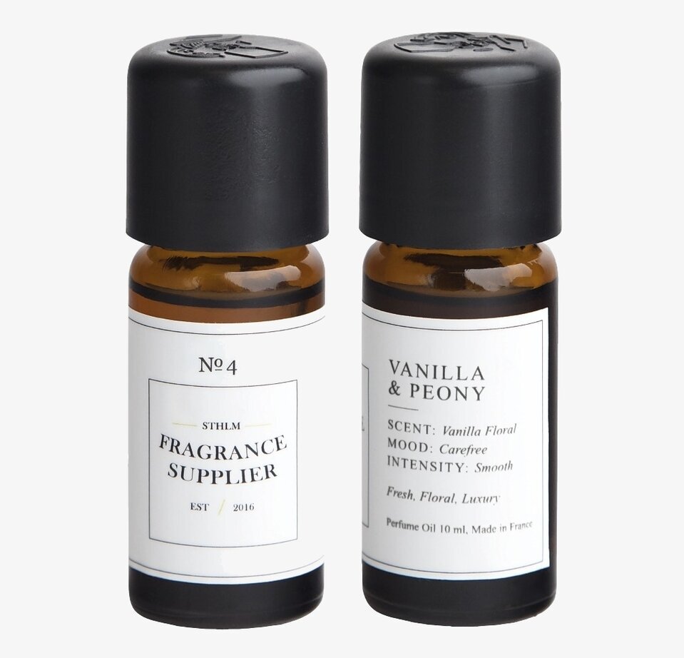 Bild av elegant doftolja med vanilj och pion i glasflaskor