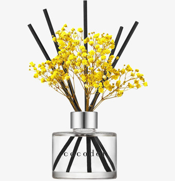 Bild av stilren doftspridare med gula blomsterdetaljer