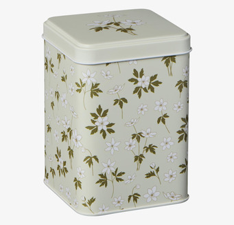 Foto av dekorativ plåtburk med blommönster och lock