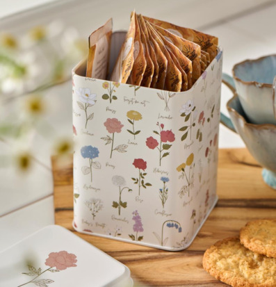 Bild av vacker plåtburk med botaniskt tema och tepåsar