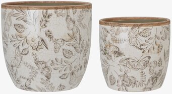 Foto av stilrena krukor med fjärilar och lövmönster