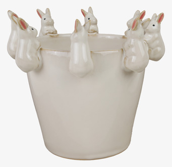 Foto av charmig kruka med kaninfigurer i vitt material