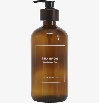 Bild av elegant glasflaska med pump för schampo