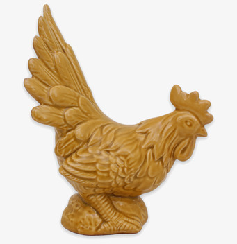 Bild av detaljrik tuppstatyett i varm ockragul nyans