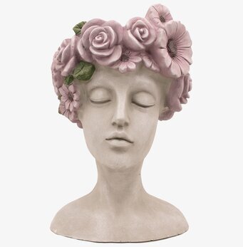 Bild av skulptur med fridfullt kvinnligt ansikte och rosor