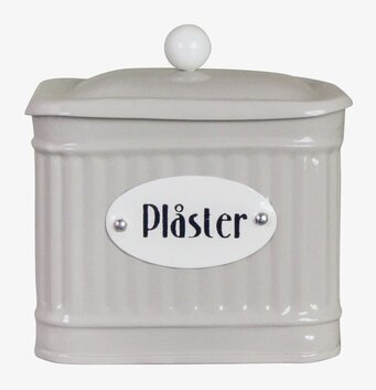 Bild av stilfull beige plåtburk för plåsterförvaring