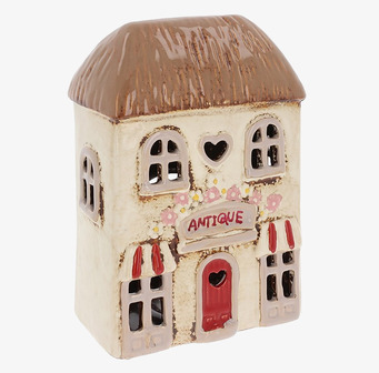 Bild av ljuslykta formad som antik butik, charmig atmosfär