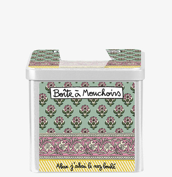 Bild av dekorativ plåtburk med blommönster och etikett