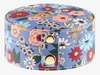 Bild av ett cirkelformat smyckesskrin med blommönster