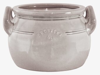 Bild av beige keramikkrus med handtag och reliefdetaljer