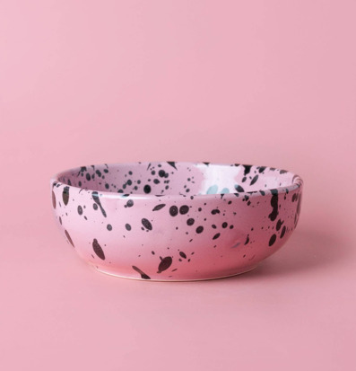 Bild av rosa keramisk rivplatta med svarta stänk och glans