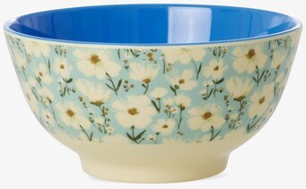 Bild av blommig skål med blå insida och gul bas mot vit bakgrund