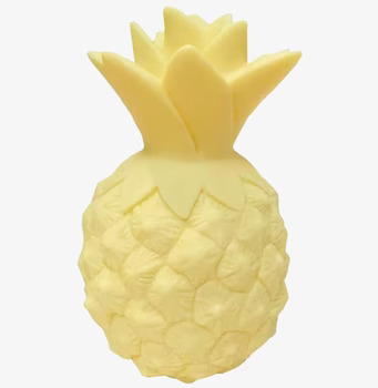 Bild av charmig ananasformad lampa i mjuk gul nyans