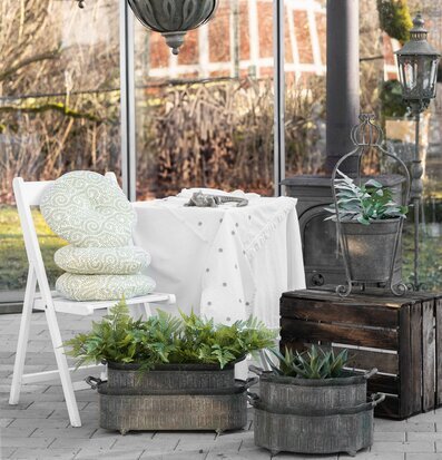 Bild: Ljus och harmonisk vinterträdgård med gröna detaljer