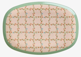 Bild av dekorativ tallrik med rutmönster, blommor och grön kant