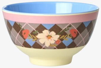 Bild av liten skål med blå insida och blommigt rutmönster