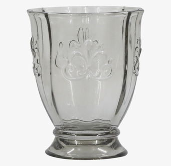 Bild på stilrent grått glas med fransk liljedekor och relief