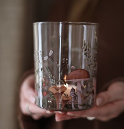 Bild: Glaslykta med höstmotiv och tänd värmeljus i närbild