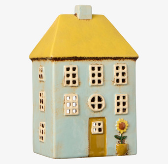 Bild dekorativ ljuslykta i keramik formad som blått hus