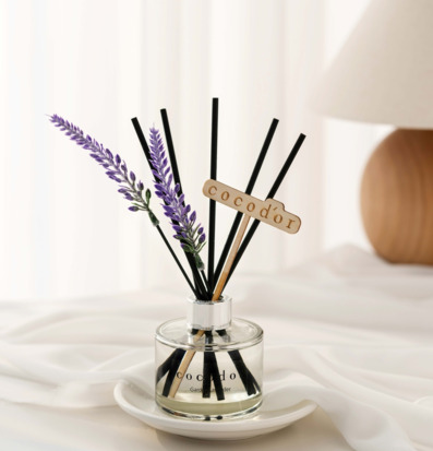 Bild på doftpinnar med lavendel i ljus och rofylld miljö