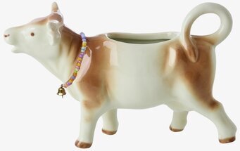 Bild av keramik-mjölkkanna formad som ko med lekfull design