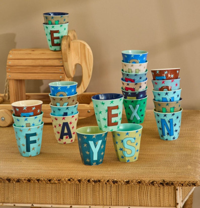 Bild på färgglada melaminmuggar med bokstäver och stjärnor