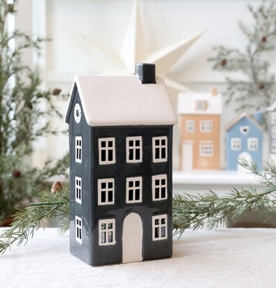 Bild av mörkgrå prydnadslykta med husform och vinterdekor