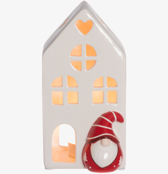 Bild av vit keramiklykta i husform med tomte och värmeljus