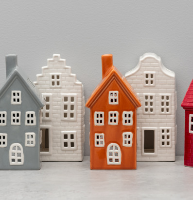 Bild på dekorativa keramikhus som ljuslyktor i olika färger