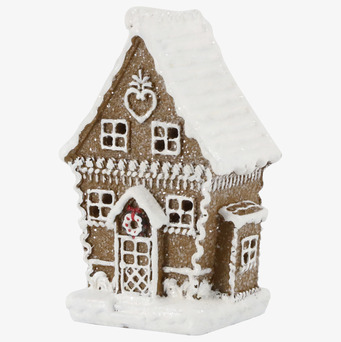 Bild av dekorativt pepparkakshus med snö och glasyrdetaljer